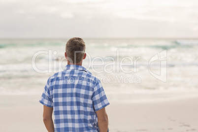 Casual man looking out to sea