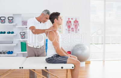 Doctor examining his patient neck Doctor examining his patient neck