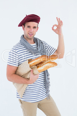 French guy with beret holding baguettes