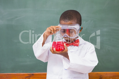Surprise pupil looking at a red liquid