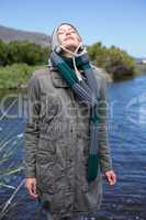 Happy casual woman at a lake