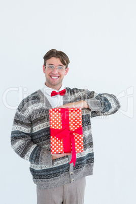 Happy geeky hipster with wool jacket holding present