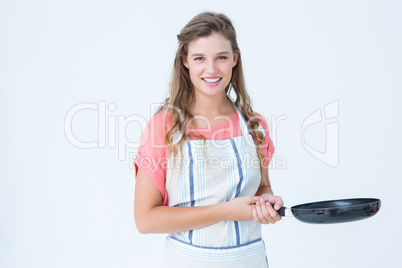 Happy hipster woman holding frying pan