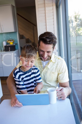 Father and son using tablet pc