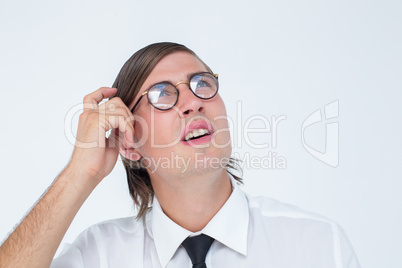 Thoughtful geeky businessman scratching his head