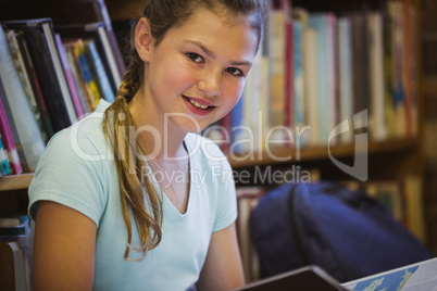 Little girl reading on library floor