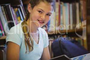 Little girl reading on library floor