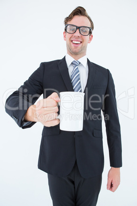 Happy geeky businessman holding coffee mug