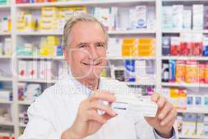 Pharmacist showing medicine box