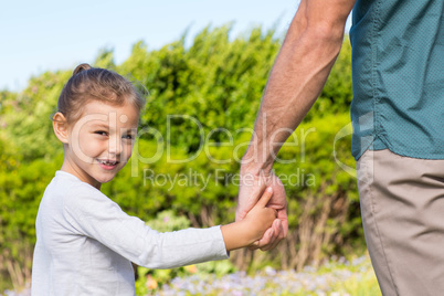 Father and daughter holding hands