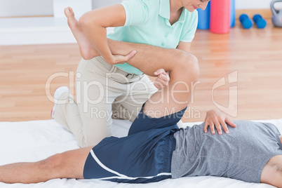 Man stretching with his trainer