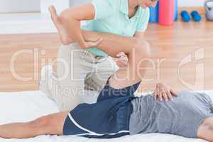 Man stretching with his trainer