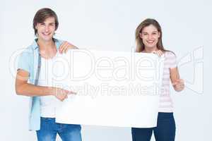 Hipster couple holding poster