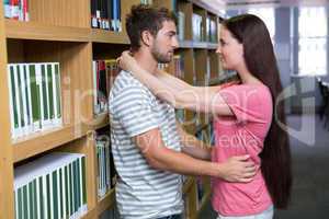 Cute couple embracing each other in the library