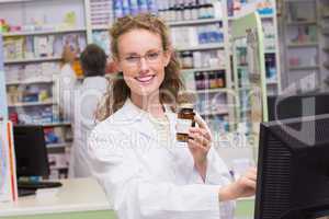 Pharmacist holding medicine bottle