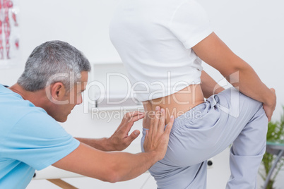 Doctor examining his patient back