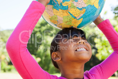 Cute little girl holding globe