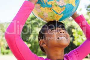 Cute little girl holding globe