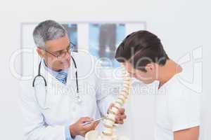 Doctor explaining anatomical spine to his patient