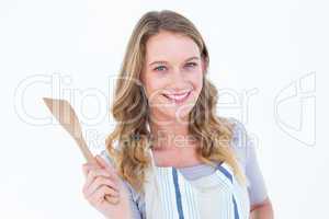 Smiling woman holding wooden spatula
