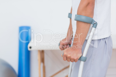 Patient standing with crutch