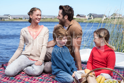 Happy family having picnic at a lake