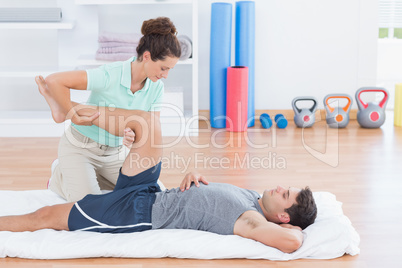 Man stretching with his trainer