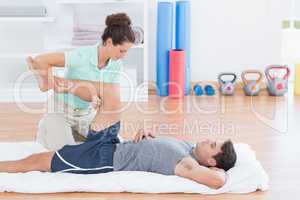 Man stretching with his trainer