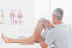 Doctor examining man leg