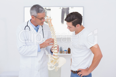 Doctor explaining anatomical spine to his patient