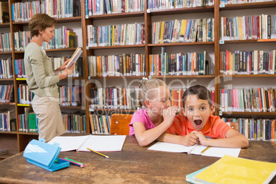 Cute pupils speaking at library