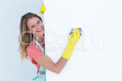 Woman cleaning white poster