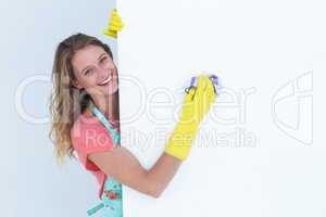Woman cleaning white poster