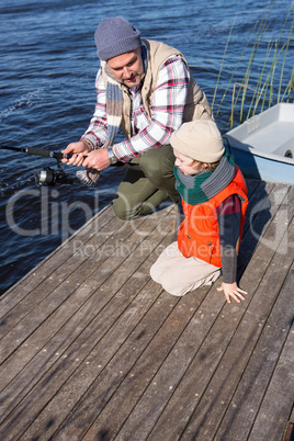 Happy man fishing with his son