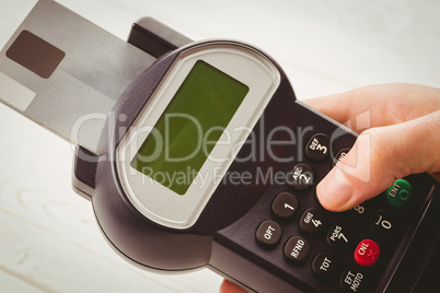 Man entering his pin on terminal