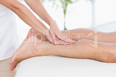 Physiotherapist doing calf massage to her patient