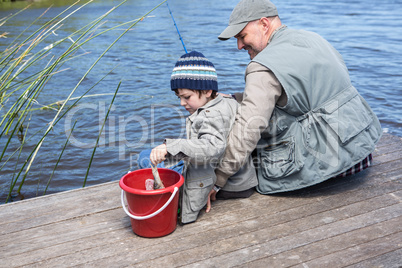 Father and son fihsing at a lake