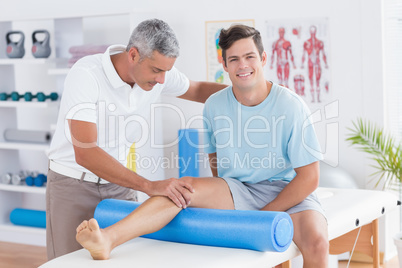 Doctor examining his patient leg