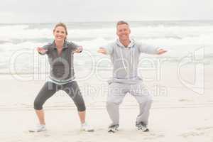 Fit couple smiling at camera