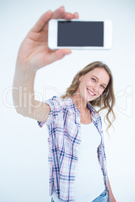 Pretty hipster taking selfie with smartphone