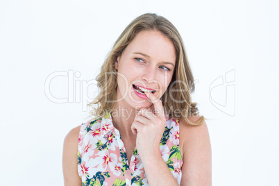 Smiling woman biting her finger