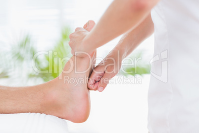 Physiotherapist doing foot massage