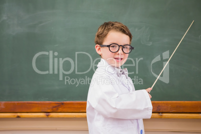 Cute pupil holding stick and pointing blackboard