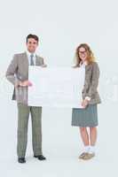 Hipster couple holding poster smiling at camera