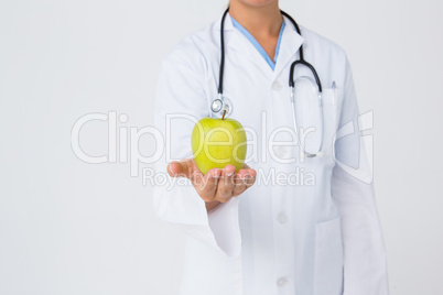 Doctor showing apple to camera