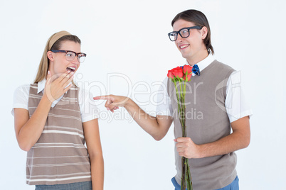 Geeky hipster offering red roses to his girlfriend