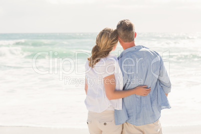 Happy couple looking out to sea