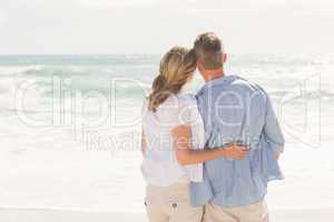 Happy couple looking out to sea