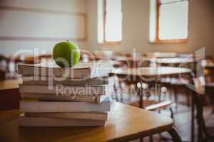 Apple on pile of books