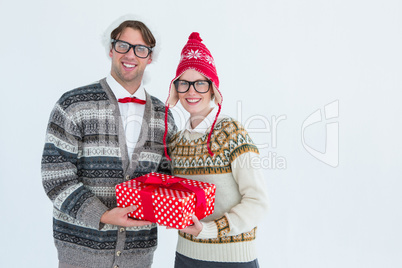 Geeky hipster couple holding present